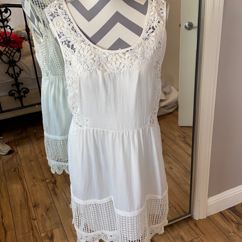 Bebe white dress size L mid length. Tank style with lace around hem and bodice